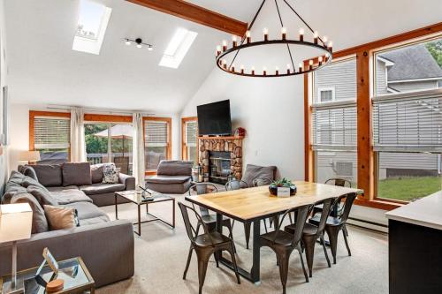 a living room with a couch and a table at House Juniper in Tannersville