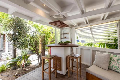 an outdoor kitchen with a bar and a window at Exceptional villa with pool and spa, Saint-Barthélemy. in Saint Barthelemy