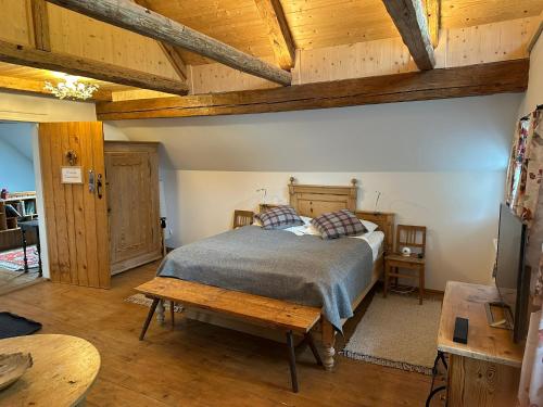 a bedroom with a bed and a wooden ceiling at Landlust Ischl in Bad Ischl