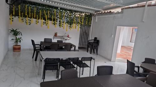 a room with tables and chairs and a man sitting at a table at Hogar de Paso Santa Teresa in Cúcuta