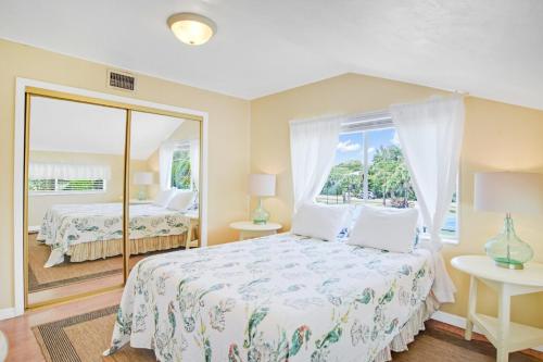 a bedroom with a bed and a large window at Sanibel Sandals & Flip Flops in Sanibel