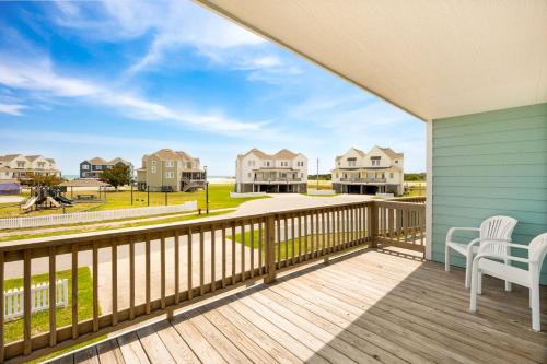 a balcony with a view of the beach and houses at CAC-15B - Pollock in Buxton