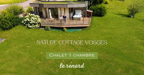 two people standing on the porch of a tiny house at Nature Cottage Vosges in Anould