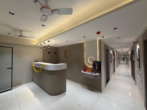 a lobby with a hallway with a counter and a hallwayngth at Hotel Prime Divine in Ahmedabad