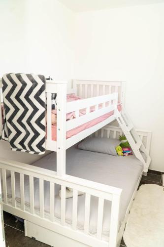 a bedroom with a bunk bed with a white bunk bed at Villa Mali Raj in Čapljina