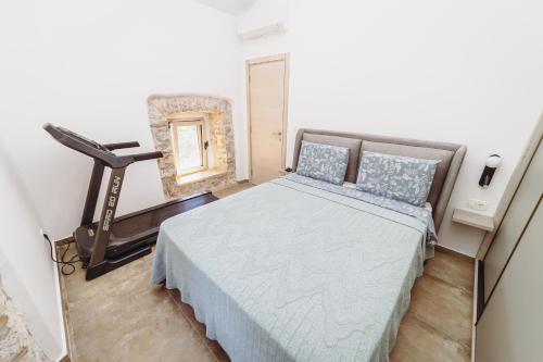 a bedroom with a bed and a chair and a mirror at Heritage House Strahinja Stone Villa with Private Pool in Popovići