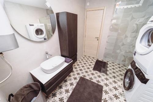 a bathroom with a sink and a washing machine at Heritage House Strahinja Stone Villa with Private Pool in Popovići