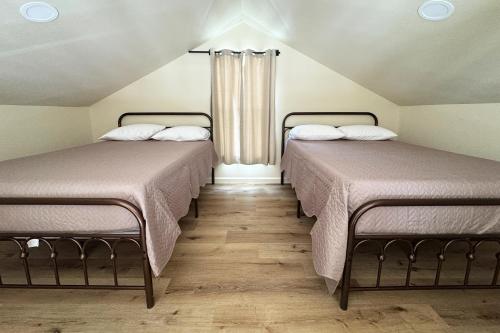 two beds sitting next to each other in a room at Old Faithful RV Park LLC in Cody