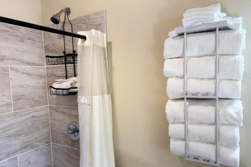 a stack of towels in a bathroom with a shower at Old Faithful RV Park LLC in Cody