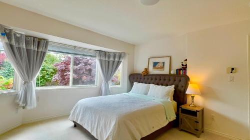 a bedroom with a bed and a window at Ocean View Home Nanaimo in Nanaimo