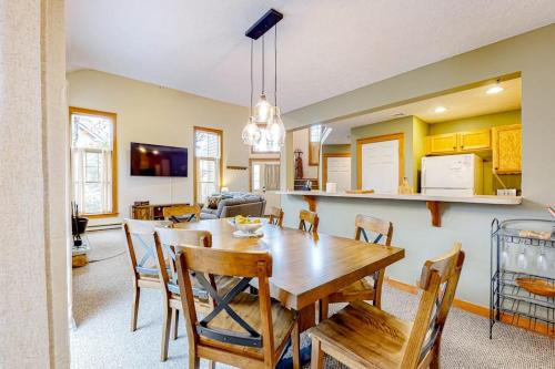 a kitchen and dining room with a wooden table and chairs at Casa Lontano in Tannersville
