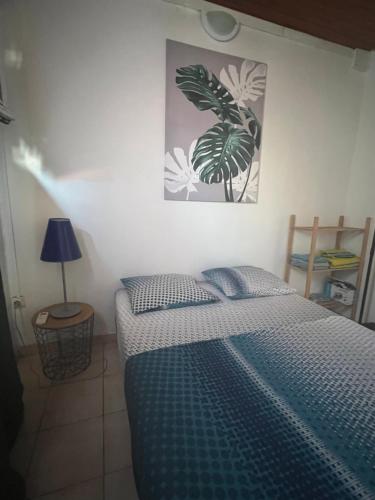 a bedroom with a bed and a picture on the wall at Ti Francois in Le François
