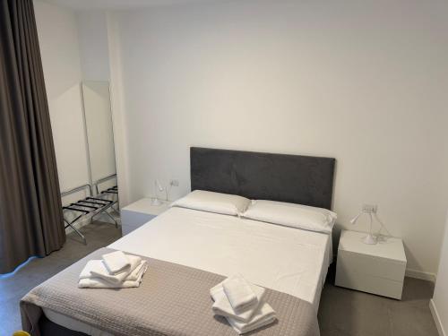 a bedroom with a bed with two towels on it at Appartamenti Nataly in Nago-Torbole