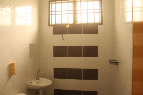 a bathroom with a sink and a toilet and a window at kluanghomestayvilla in Kluang