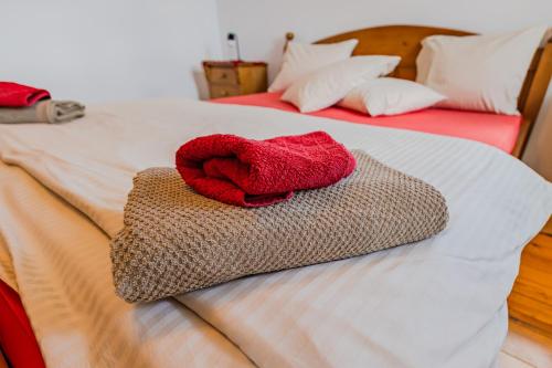 two red towels are sitting on a bed at Casa Koenigstein Private Hilltop Villa in Fundata