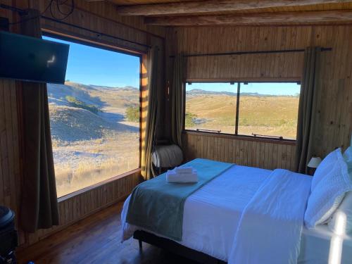 a bedroom with a bed and a large window at Cloud Valley in Bom Jardim da Serra