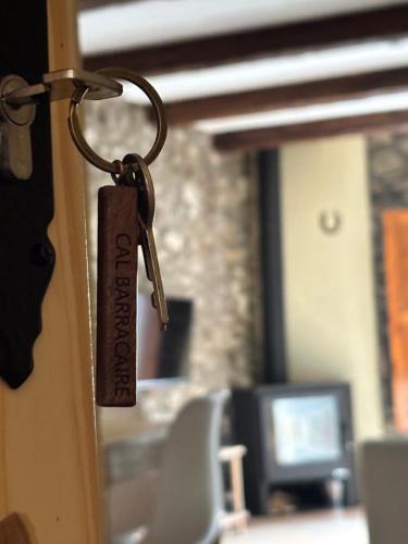 a key hanging on a door in a room at Apartament Cal Barracaire in Vilallonga de Ter