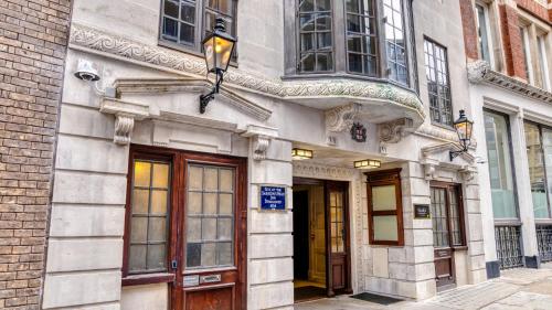 a building with doors and windows on a street at hub London Farringdon - Old Bailey in London