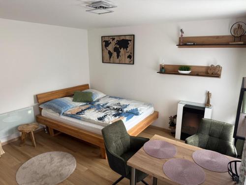 a bedroom with a bed and a table and chairs at Apartment WOLF in Kořenov