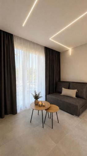 a living room with a couch and a table at Ammos Maisonettes in Pefkari