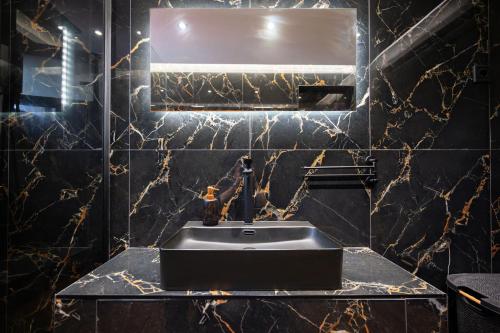 a bathroom with a sink and a mirror at Divodi View in Mytikas