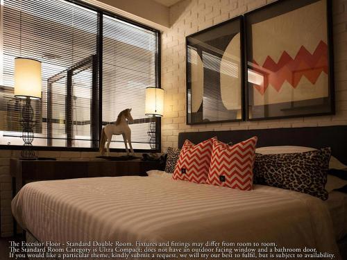 a bedroom with a bed with a horse statue next to a window at M Boutique Hotel in Ipoh