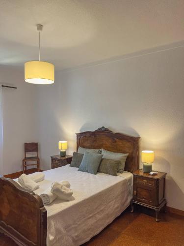 a bedroom with a large bed with two night stands at Port'Espada Countryhouse in Marvão