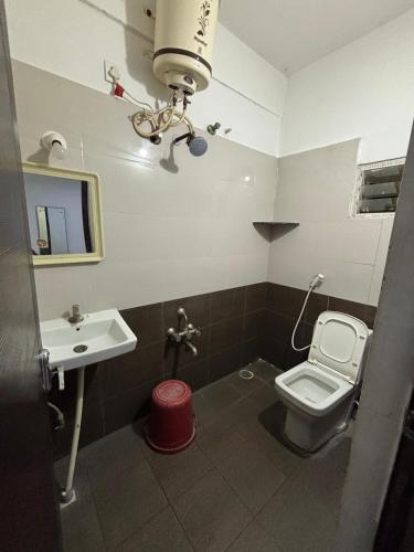 a bathroom with a toilet and a sink at SLV Royal Residency Hotel in Bidadi
