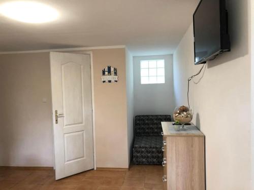 a living room with a chair and a television at Pärlan 2 in Balatonboglár