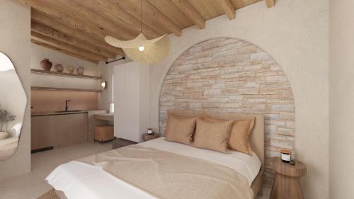 a bedroom with a bed and a brick wall at Pharos by Premium Key in Skiathos