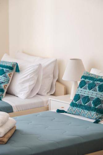 a bedroom with two beds with white pillows at Plakias Panorama Homes in Plakias