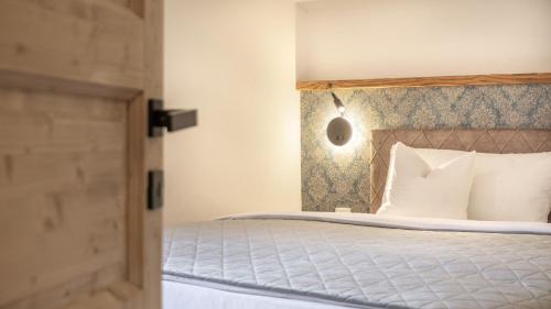 a bedroom with a bed with a wooden headboard at Haus Georg in Leutasch
