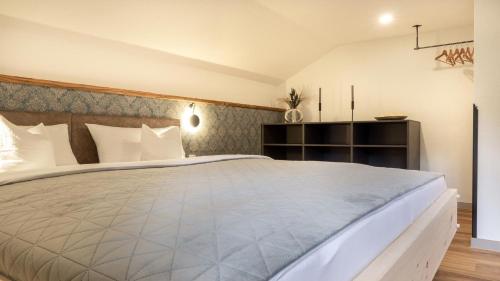 a bedroom with a large white bed in a room at Haus Georg in Leutasch