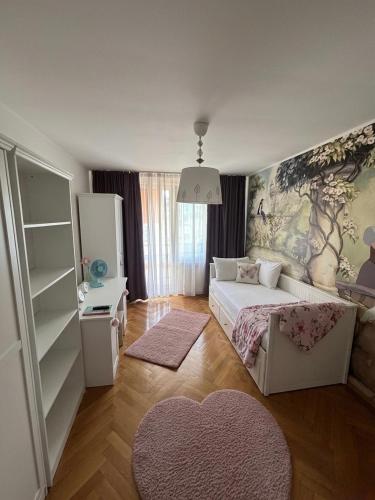 a bedroom with a bed and a large painting on the wall at Cu Tâmpa la fereastră - Spacious Apartment with Mountain View & 2 Free Parking Spaces in Braşov