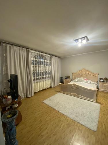 a bedroom with a bed and a large window at Літо in Bushtyno