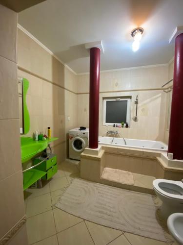 a bathroom with a tub and a sink and a toilet at Літо in Bushtyno