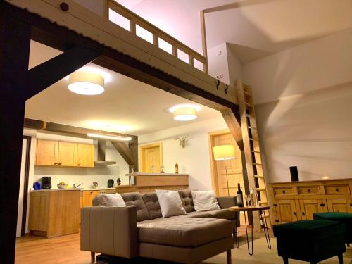 a living room with a couch and a loft at Ferienpark Vorauf Fepark 53 in Siegsdorf