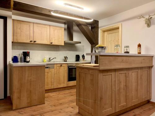 a kitchen with wooden cabinets and a counter top at Ferienpark Vorauf Fepark 53 in Siegsdorf