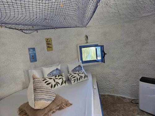 a room with a couch with pillows and a window at Divlja dolina in Budva