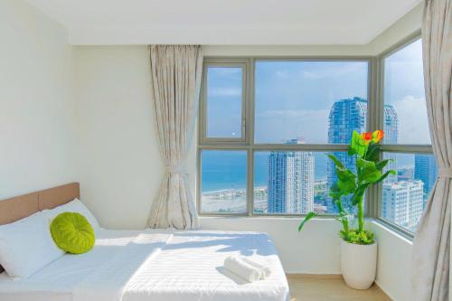 a bedroom with a bed and a large window at The Song Apartment Vung Tau - Căn Hộ Du Lịch 5 Sao Cạnh Biển Vũng Tàu in Vung Tau