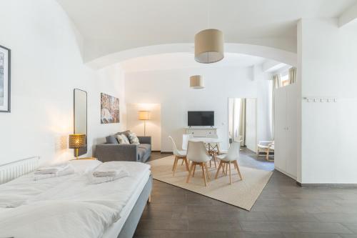 a bedroom with a bed and a living room at cityswap- Wien 2 District in Vienna