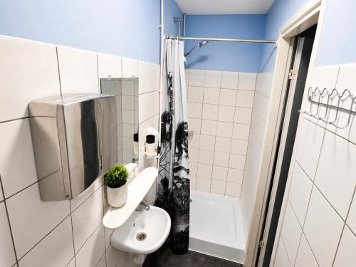 a bathroom with a sink and a shower at Paide Event Center Hostel in Prääma