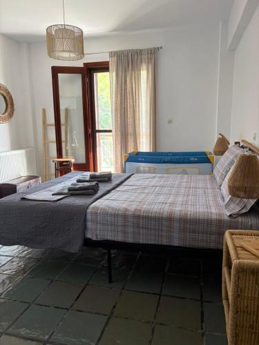 a bedroom with a bed with a blanket on it at Aether House Αιθήρ in Toroni
