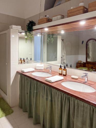 a bathroom with two sinks and two mirrors at Casa Janca Pizzo in Pizzo
