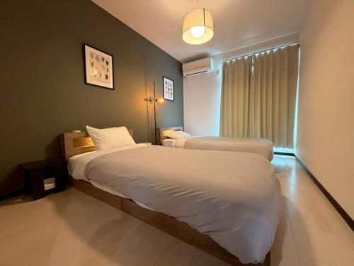 a hotel room with two beds and a window at ura Auberge Craft in Hokancho