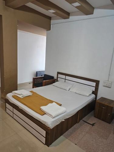 a bedroom with a bed with two towels on it at Relaxinn Dwaraka in Mānantoddy
