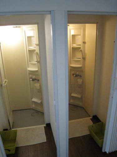 a bathroom with two closets with their doors open at Hotel Eco Dogo in Matsuyama