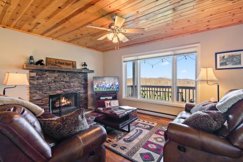 a living room with two couches and a fireplace at A Place Apart in Blowing Rock