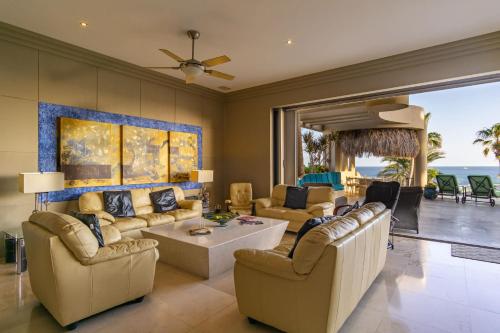 a living room with couches and a table at Views to El Arco, Famous Cabo San Lucas bay rock formation in El Pueblito