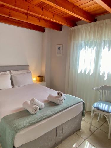 a bedroom with a bed with towels on it at A & D Houses in Patra